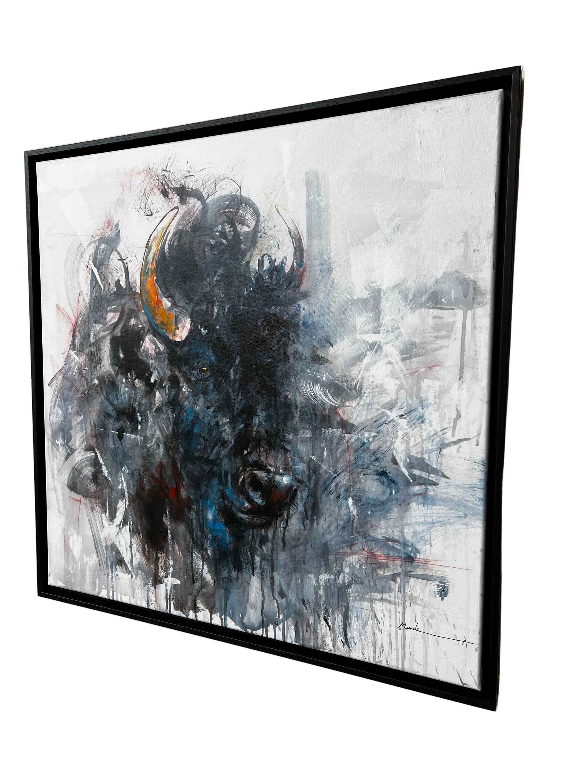 Abstract painting of a bull head in a black frame.