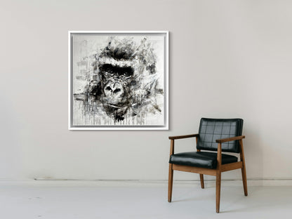 Framed abstract artwork of a gorilla's face on a wall above a chair.