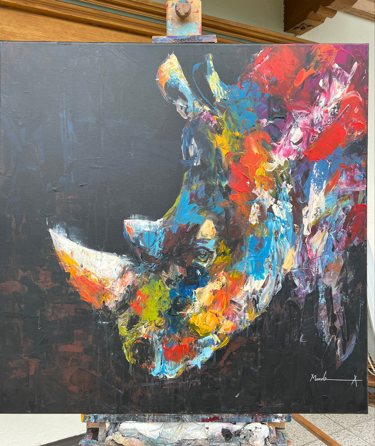 Abstract rhino painting on a black background with vibrant colors