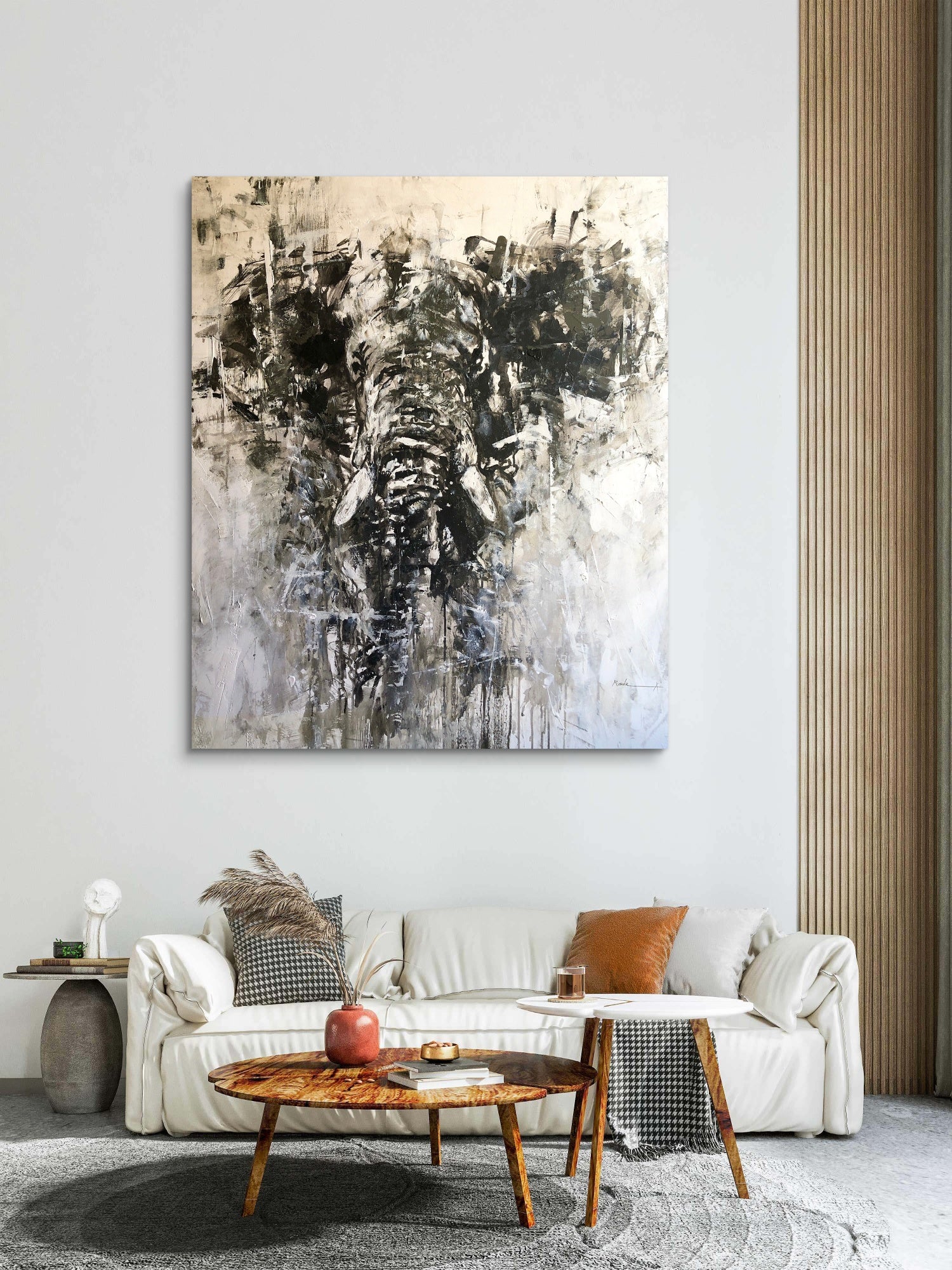 Abstract elephant painting on a wall above a sofa in a living room